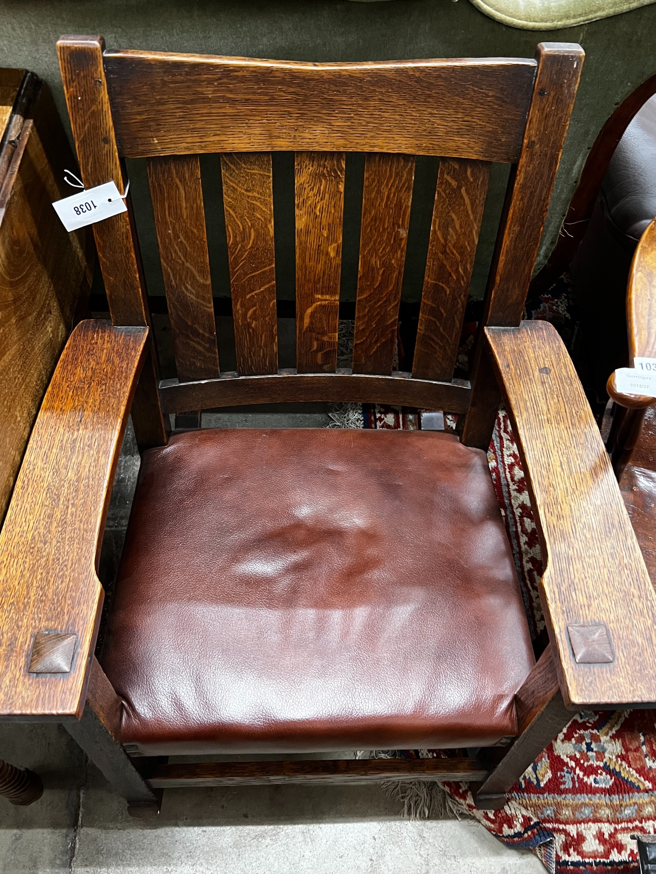 An early 20th century Stickley oak rocking chair, width 66cm, depth 50cm, height 86cm